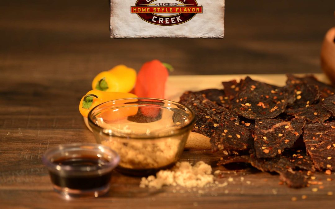 a photo of jerky surrounded by some of its all natural ingredients proving jerky is a healthy snack