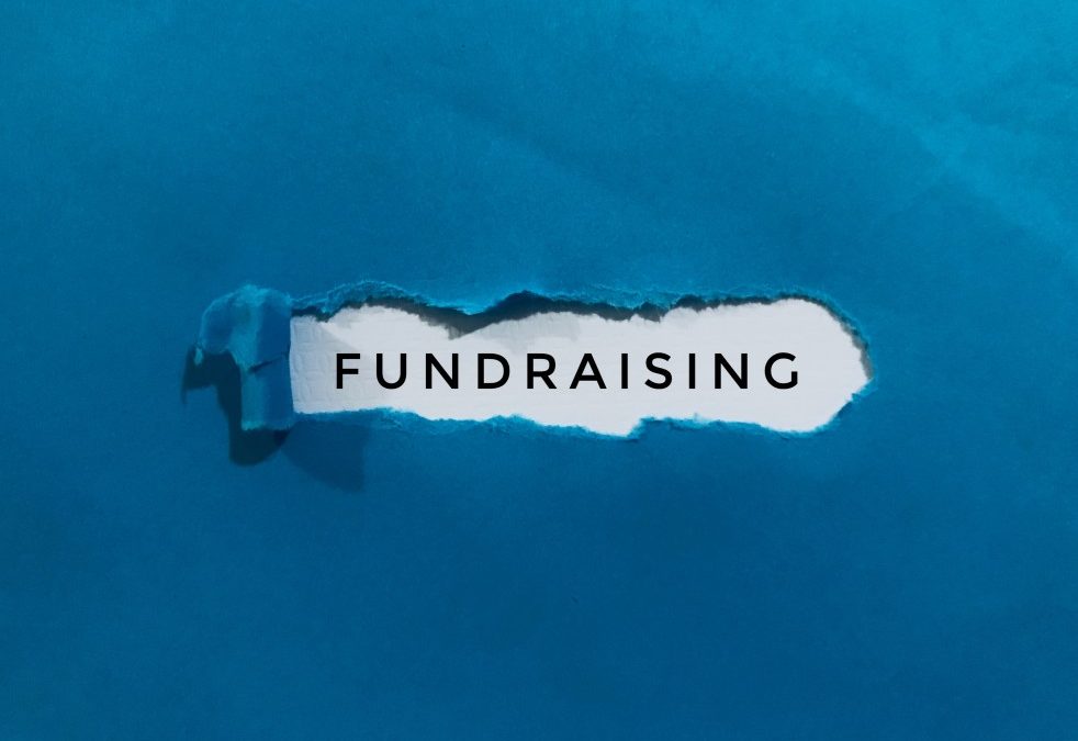 blue background with a rip in the middle to expose the word fundraising